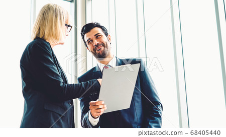 Two business people talk project strategy at office 68405440