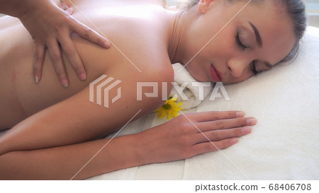 Woman gets back massage spa by massage therapist. Woman gets back massage spa by massage therapist. 68406708