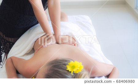 Woman gets back massage spa by massage therapist. Woman gets back massage spa by massage therapist. 68406980