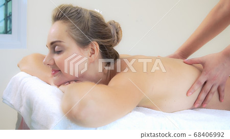 Woman gets back massage spa by massage therapist. Woman gets back massage spa by massage therapist. 68406992