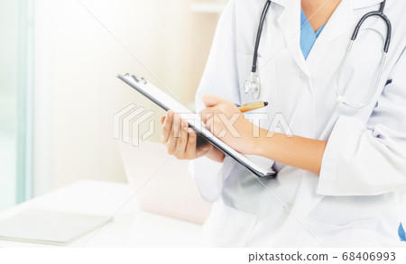 Young female doctor working in hospital office. Young female doctor working in hospital office. 68406993