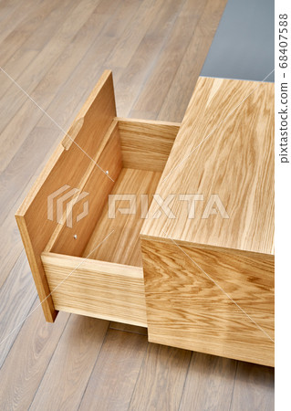 Floating media cabinet in contemporary living room. Wall mounted wooden cabinet with open drawers 68407588