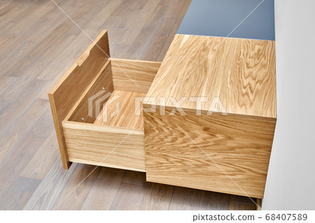 Floating media cabinet in contemporary living room. Wall mounted wooden cabinet with open drawers 68407589