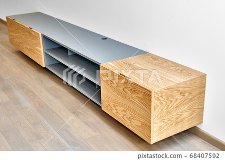 Floating media cabinet in contemporary living room. Wall mounted wooden cabinet 68407592