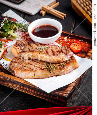Grilled juicy steak sauce salad on wooden board Grilled juicy steak sauce salad on wooden board 68408024