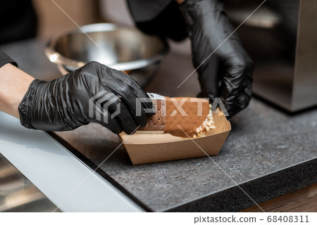 Making chocolate ice cream with topping 68408311