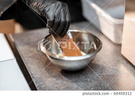 Making chocolate ice cream with topping 68408312