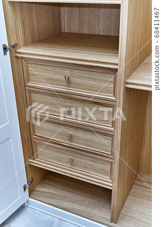 White wardrobe with wooden drawers and shelves. Wooden filling of wardrobe White wardrobe with wooden drawers and shelves. Wooden filling of wardrobe 68411467