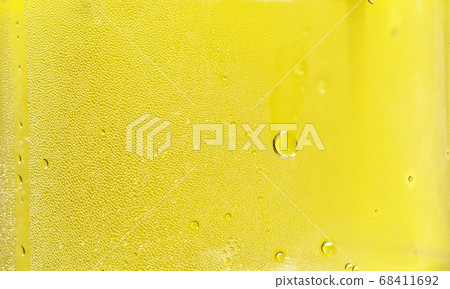 Many water drops on the surface of a transparent plastic bottle on yellow background, Abstract Texture for add text or graphic design  68411692