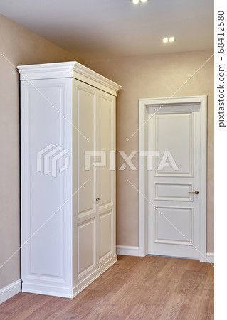 Classic wardrobe and interior door in beige interior 68412580