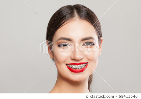 Cheerful woman with braces on teeth. Cheerful woman with braces on teeth. 68413546