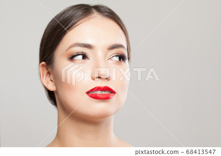 Young model woman with braces on teeth on white Young model woman with braces on teeth on white 68413547