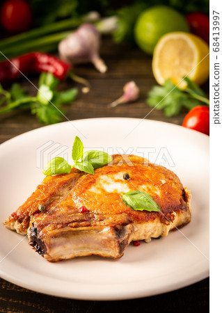 Fried pork entrecote on the bone 68413997