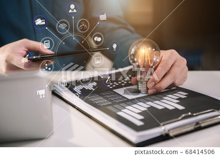 Business man using digital tablet analyzes business data, busy working on laptop computer with smart phone and business report on office desk. Business man using digital tablet analyzes business data, busy working on laptop computer with smart phone and business report on office desk. 68414506