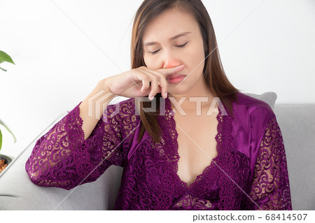 Asian woman stuffy nose. 68414507