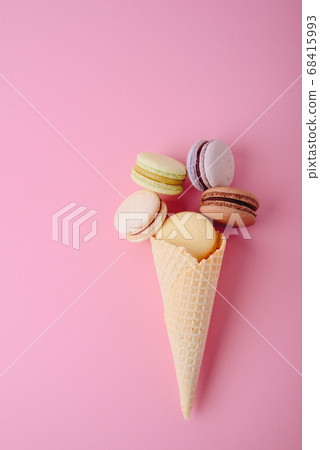 Several colorful macaroon cakes on a colored 68415993