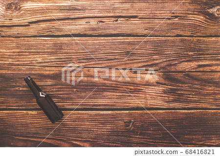 Flat lay of a beer bottle against a rustic wood 68416821