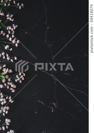 Flat lay of white flowers against black marble 68416874