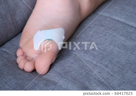 Wound sticked plaster on child's foot, closeup view. Wound sticked plaster on child's foot, closeup view. 68417025