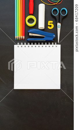 Top view on colorful stationery. Back to school flat lay concept. Vertical blackboard background with copy space. 9-16 ratio for mobile applications. 68417209