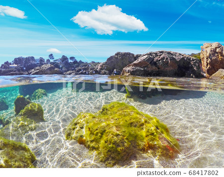 Colorful water in Alghero shore 68417802