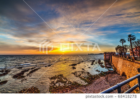 Colorful sky over Alghero shoreline 68418278