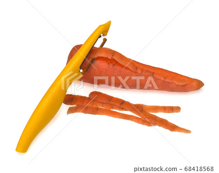 Yellow peeler, used to peel a carrot on white background. Knife, peeler for vegetables and fruits 68418568