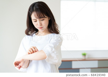 A young woman who cares about the rough skin of his arms A young woman who cares about the rough skin of his arms 68419340