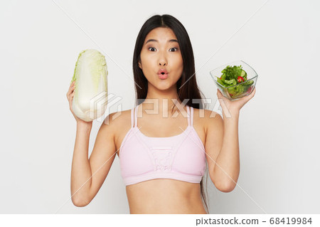Eating beautiful woman slim figure salad in a plate and vegetables 68419984