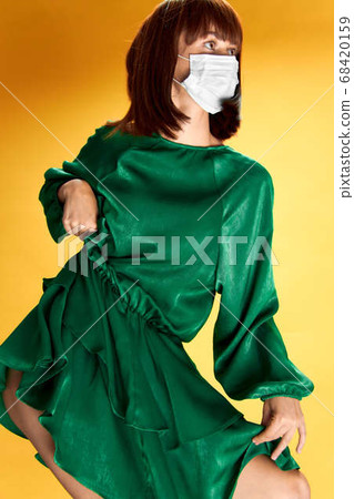 Woman in fashion dress posing in medical mask virus covid-19 68420159