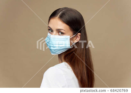 Attractive woman stylish clothes in a face mask allergy  68420769