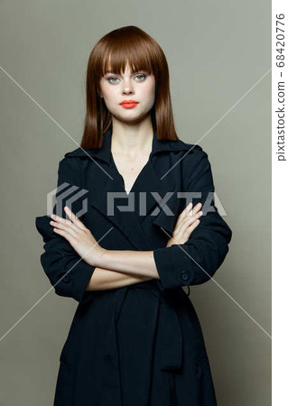 woman with bright makeup and in a black coat 68420776