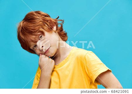 red-haired boy with a boring expression leaned to the side red-haired boy with a boring expression leaned to the side 68421091