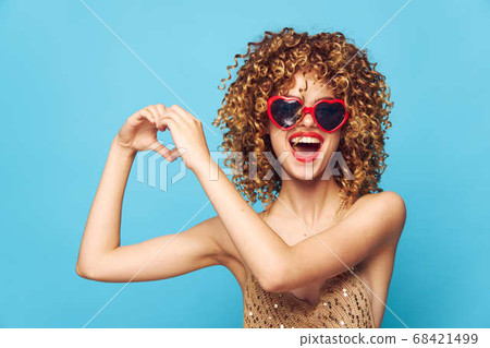 Emotional blonde expression of feelings on an isolated blue background Emotional blonde expression of feelings on an isolated blue background 68421499