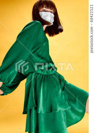 Woman in fashion dress posing in medical mask virus covid-19 68421521