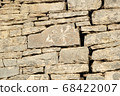 Ancient petroglyphs on the stone walls of an old house 68422007