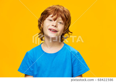 cute red-haired child in a blue t-shirt  68422386