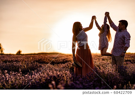 silhouette family in lavender field at sunset. silhouette family in lavender field at sunset. 68422709