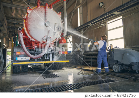 Silhouette of female person working at car wash Silhouette of female person working at car wash 68422750