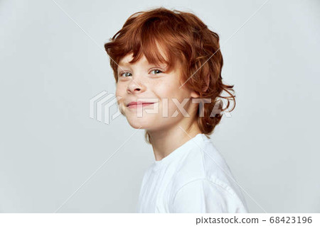 Cheerful redhead boy smile white t-shirt cropped view studio  68423196
