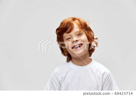 Cheerful red-haired boy studio cropped view white t-shirt Cheerful red-haired boy studio cropped view white t-shirt 68423714