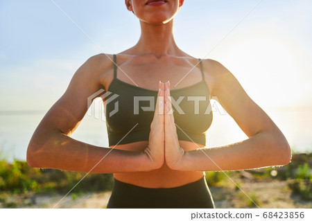 Young woman practicing yoga on sunny day 68423856