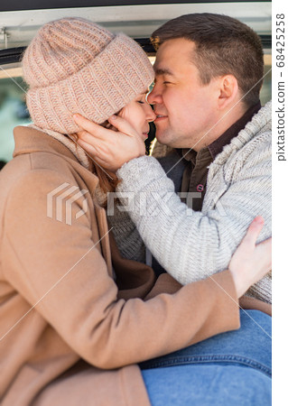 Man and woman sitting in trunk of the white car Man and woman sitting in trunk of the white car 68425258