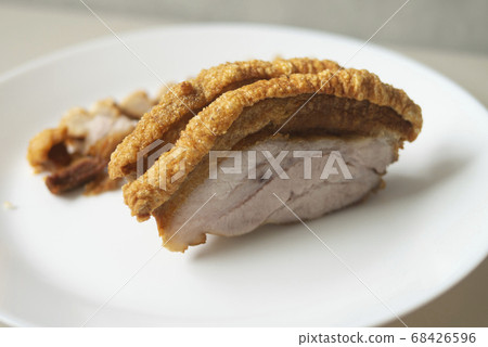 A slice of crispy pork shows its layer for Asian traditional food roasted and deep fried menu A slice of crispy pork shows its layer for Asian traditional food roasted and deep fried menu 68426596