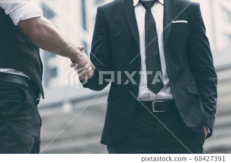 Businessmen making handshake for dealing business Businessmen making handshake for dealing business 68427391