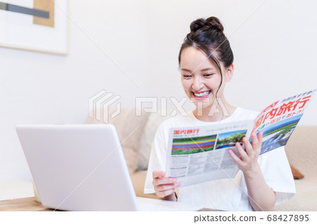 Young woman planning a trip 68427895