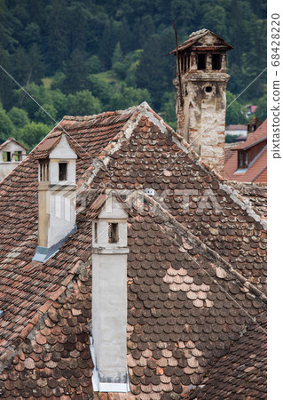 Aerial view on red tiled roofs of medieval Brasov town in Transylvania, Romania. Europe Aerial view on red tiled roofs of medieval Brasov town in Transylvania, Romania. Europe 68428220
