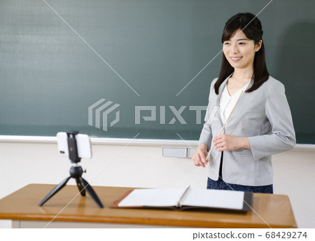 Teacher delivering online lessons Teacher delivering online lessons 68429274