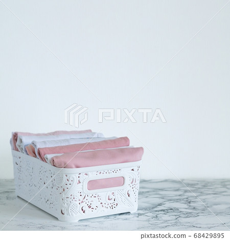 Neatly folded clothes in the organizer box for wardrobe. Vertical storage concept. Copy space Neatly folded clothes in the organizer box for wardrobe. Vertical storage concept. Copy space 68429895
