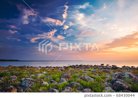 Rocky shores at the sea in sunset light Rocky shores at the sea in sunset light 68430044